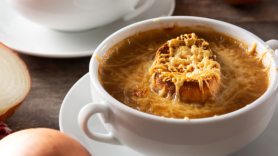 Traditional french onion soup on wooden table