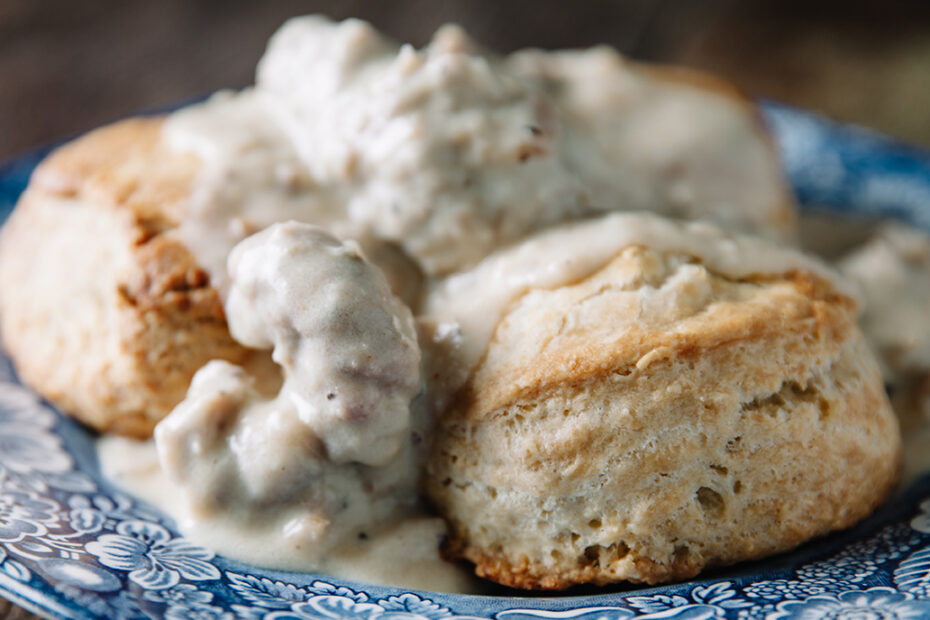 blue plate with biscuits and sausage gravy