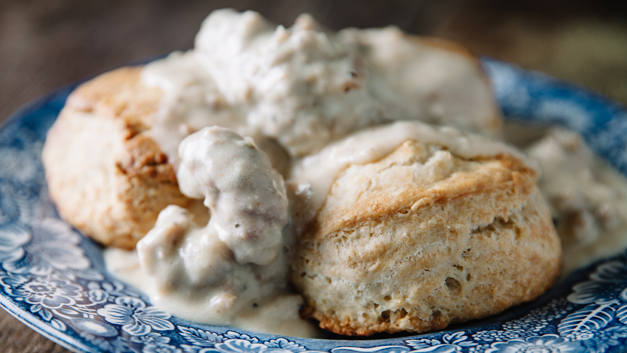 blue plate with biscuits and sausage gravy