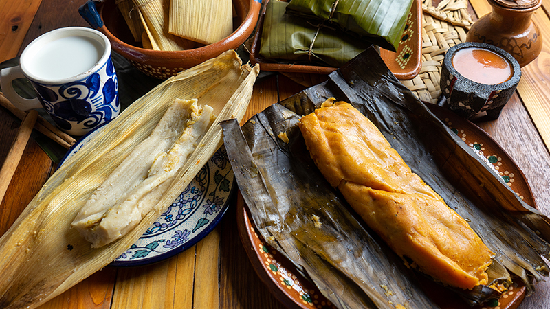 Authentic mexican tamal in banana and corn leaf